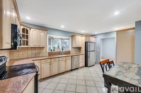 A kitchen with a granite countertop and a refrigerator.