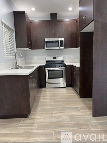A kitchen with a stove top oven and microwave above it.