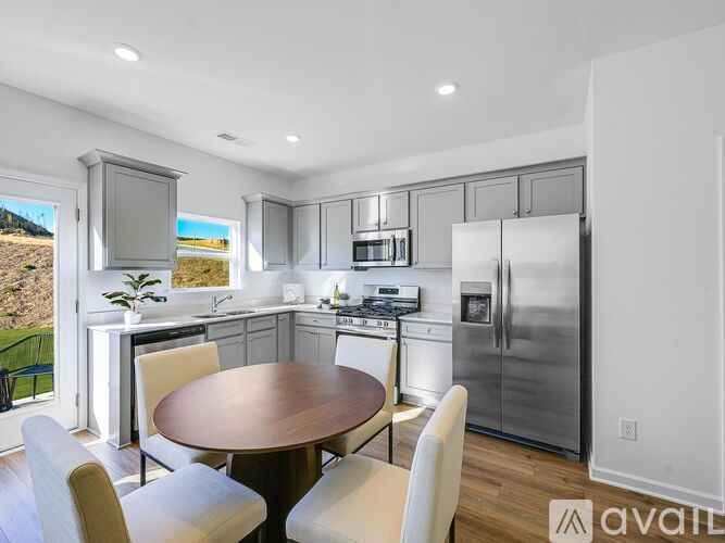 A modern kitchen with a dining table and chairs.