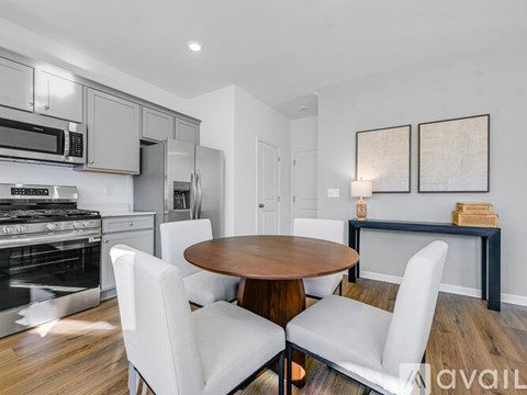 A modern kitchen with a dining table and chairs.