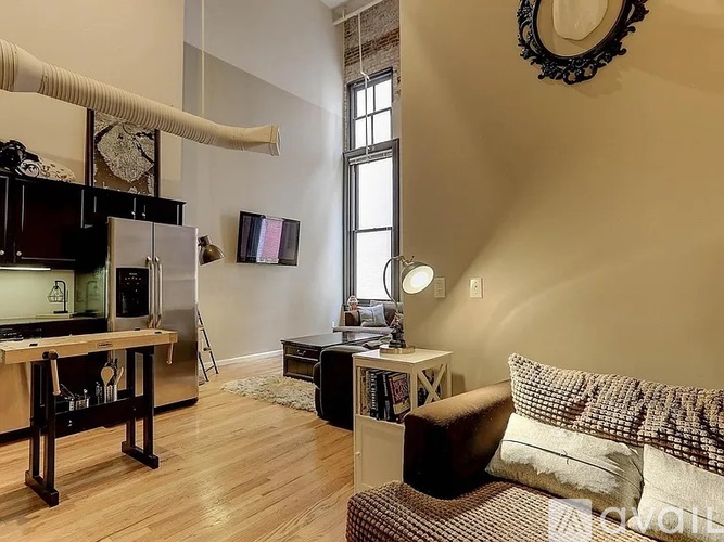 A living room with a brown couch and a wooden table.