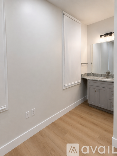 A bathroom with a sink and a mirror.
