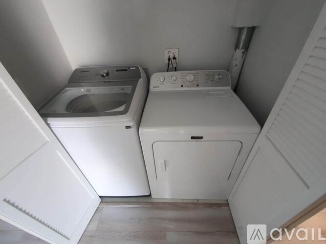 A small laundry room with a washer and dryer.