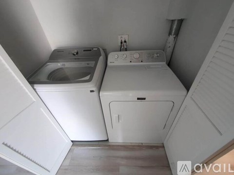 A small laundry room with a washer and dryer.