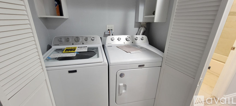 A small laundry room with a washer and dryer.