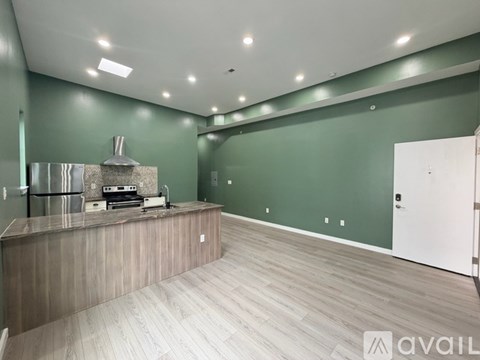A kitchen with a wooden counter and a white fridge.