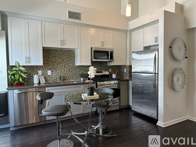 A kitchen with a table and chairs in the middle.