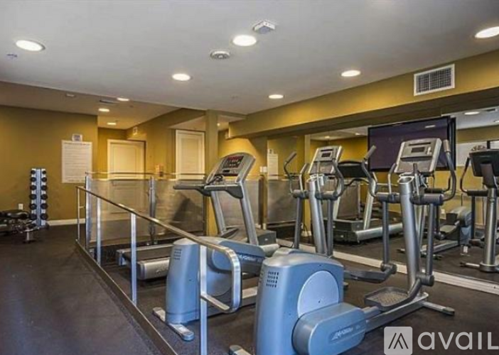 A gym with treadmills and elliptical machines.