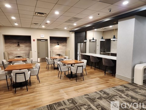 A modern dining area with wooden tables and chairs.