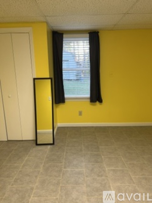 A room with yellow walls and a white door.