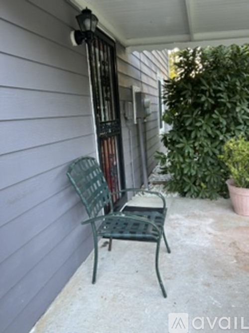 A patio with a chair and a table.
