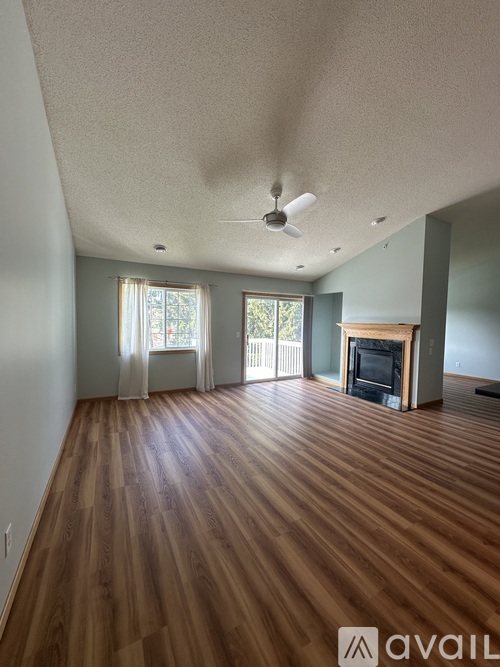 A room with wooden floors and a fireplace.
