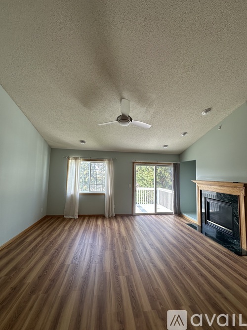 A room with wooden floors and a fireplace.