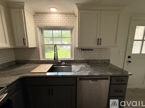 A kitchen with a sink and a window.