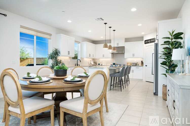 A modern dining room with a round table set for six.