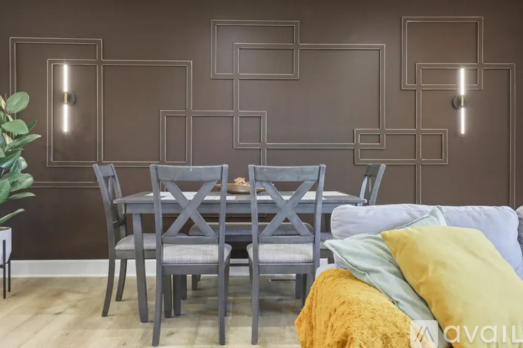 A dining room with a table set for four.