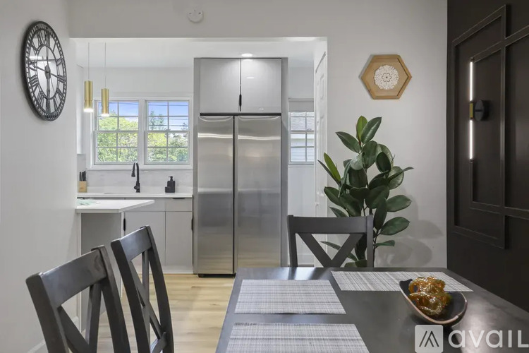 A modern kitchen with a dining table set for two.