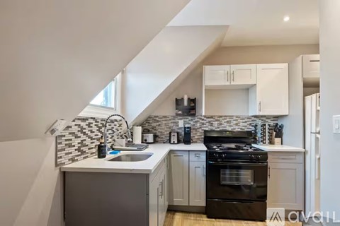 A kitchen with a black oven and a white countertop.