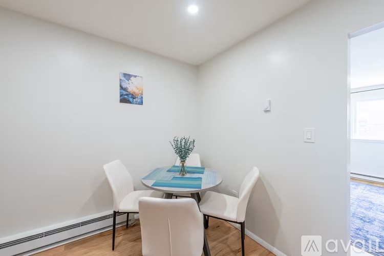A dining room with a table and chairs.