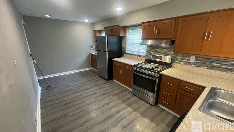 A kitchen with wooden cabinets and stainless steel appliances.