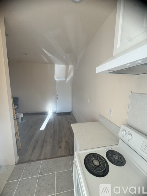 A kitchen with a stove top oven and a counter.
