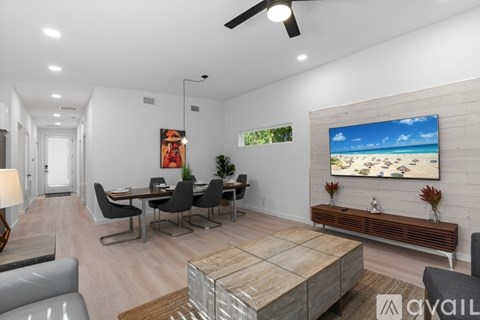 A modern living room with a dining table and chairs.