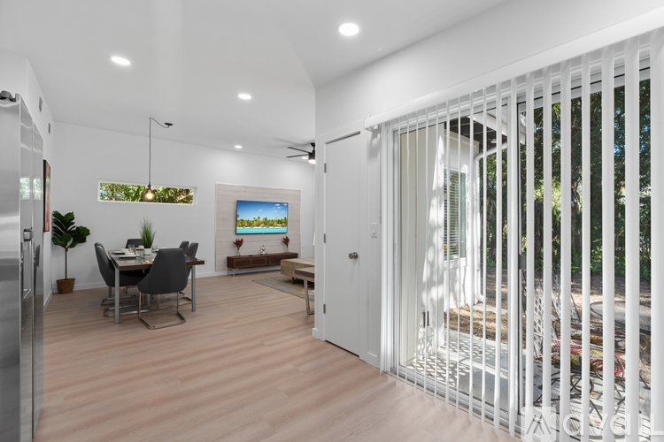 A modern kitchen with a dining table and chairs.