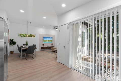 A modern kitchen with a dining table and chairs.