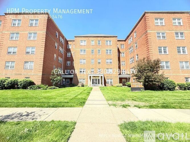 A red brick building with the words HPM Property Management on the top left corner.