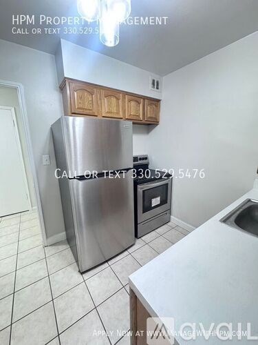 A kitchen with a stainless steel refrigerator and a white countertop.