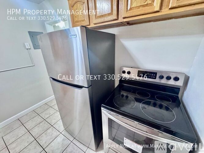 A kitchen with a stainless steel refrigerator and stove.