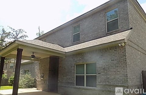 A house with a covered porch and a stone exterior.