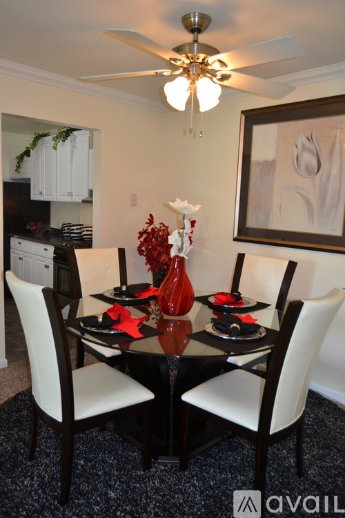 A dining room with a table set for a meal.