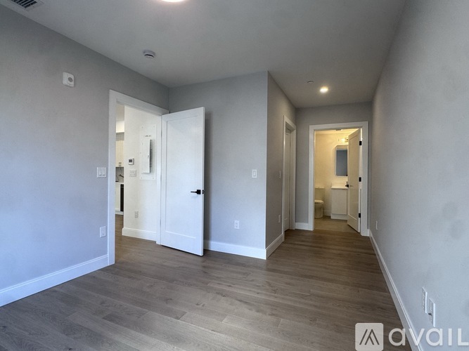 A room with a white door and a white wall.