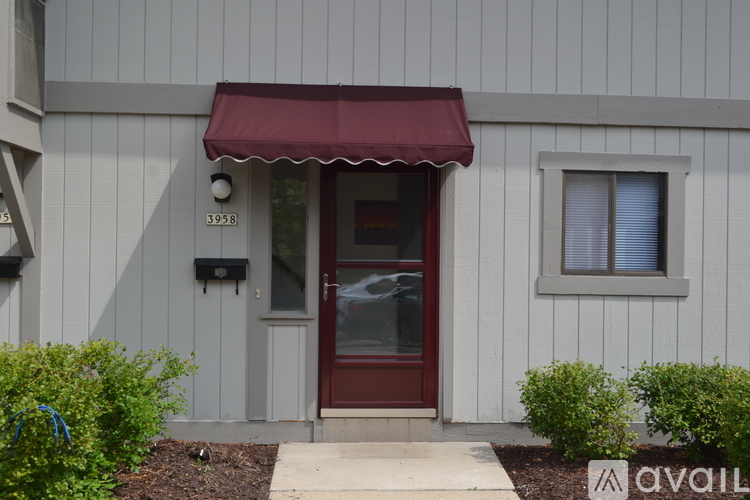 A building with a red awning and a door with a glass window.