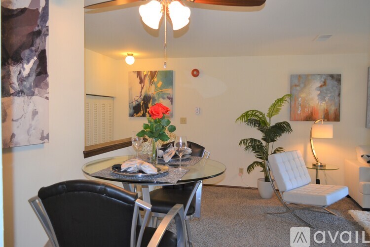 A dining room with a round table and chairs.