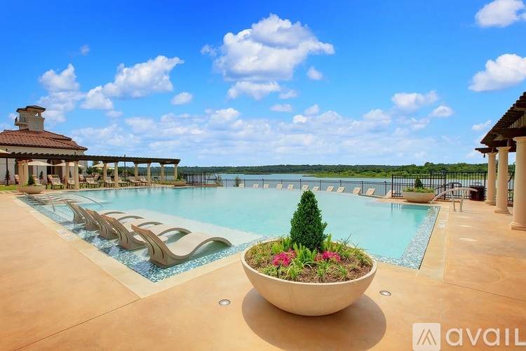A pool area with a large bowl of flowers in the foreground.
