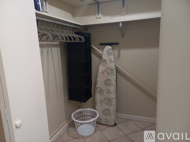 A small closet with a towel on the floor.