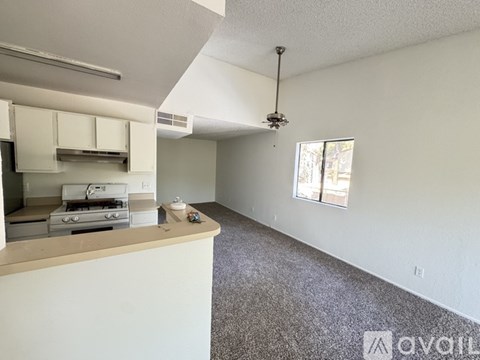 A kitchen area with a stove top oven and a window.