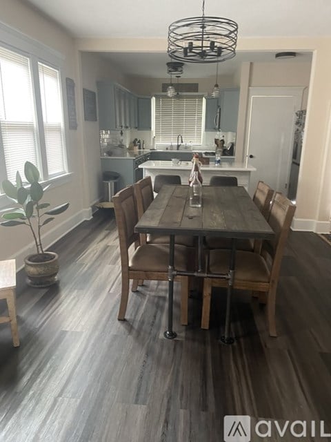 A dining room with a wooden table and chairs.