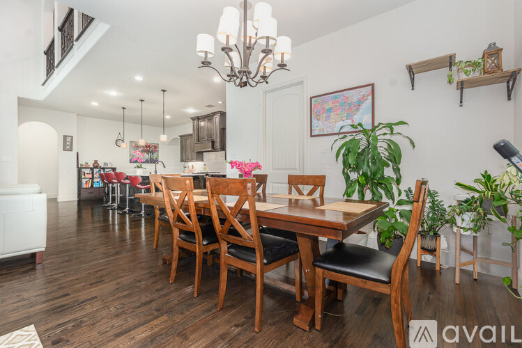 A dining room with a wooden table and chairs.