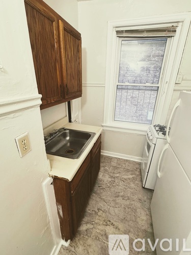 A small kitchen with a sink and a window.