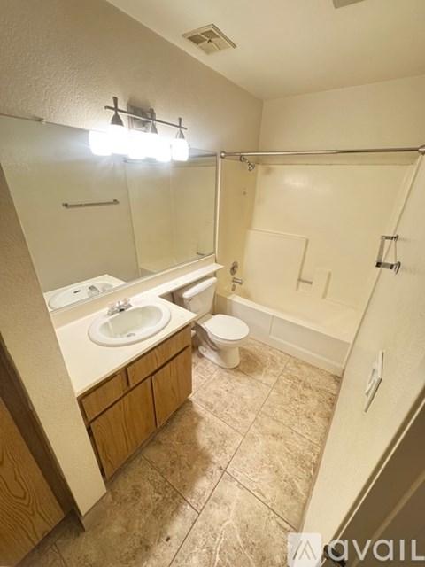 A bathroom with a toilet, sink, and bathtub.