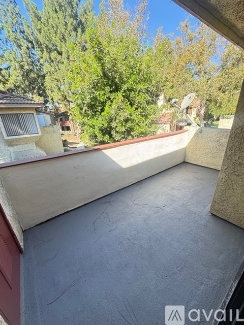 A balcony with a view of a residential area.