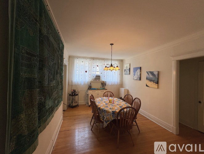 A dining room with a table set for four.
