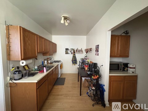 A kitchen with wooden cabinets and a white counter top.