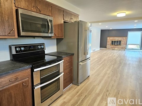 A kitchen with wooden cabinets and a black stove top oven.