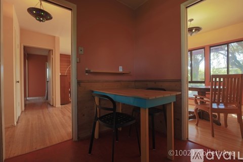 A dining room with a table and chairs.