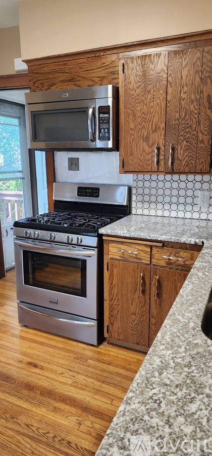 A kitchen with a stove top oven and microwave above it.