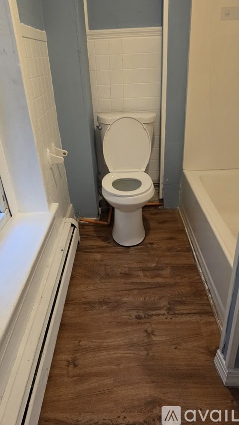 A white toilet in a bathroom with blue walls.